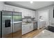 Well-lit kitchen showcases stainless steel appliances, granite countertops, and convenient laundry area at 13285 Arbor Pointe Cir # 202, Tampa, FL 33617