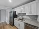 Bright kitchen equipped with stainless steel appliances and white cabinets with granite countertops at 13285 Arbor Pointe Cir # 202, Tampa, FL 33617