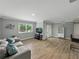 Bright living room with wood-look tile floors, neutral walls, slider door to outdoor patio, and modern finishes at 13285 Arbor Pointe Cir # 202, Tampa, FL 33617