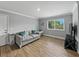 Cozy living room with a plush couch, natural light from the window, and stylish decor, creating a comfortable atmosphere at 13285 Arbor Pointe Cir # 202, Tampa, FL 33617