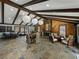 Resident lounge area with a fireplace, wood-beamed ceilings, slate flooring, and a seating area at 13285 Arbor Pointe Cir # 202, Tampa, FL 33617