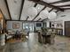Resident lounge with slate floors, wood-beamed ceilings, a dining table, and access to the pool area at 13285 Arbor Pointe Cir # 202, Tampa, FL 33617