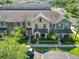 An aerial view of a charming two-story townhouse with manicured landscaping and a welcoming front porch at 14135 Stowbridge Ave, Tampa, FL 33626