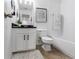Well-lit bathroom featuring a white vanity, tile flooring, and a shower-tub combination at 14135 Stowbridge Ave, Tampa, FL 33626