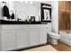 Modern bathroom featuring a granite countertop, white cabinets, and a tiled shower-tub combination at 14135 Stowbridge Ave, Tampa, FL 33626
