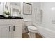 Clean bathroom featuring white fixtures and a shower-tub combination at 14135 Stowbridge Ave, Tampa, FL 33626