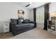 Bedroom with a comfortable sofa-bed, window with shutters, and ceiling fan at 14135 Stowbridge Ave, Tampa, FL 33626