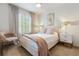 Inviting bedroom with a cushioned bed, large window, and matching bedside tables and lamps at 14135 Stowbridge Ave, Tampa, FL 33626