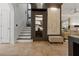 View of the home's entryway with staircase, tile flooring, and access to the adjacent living room at 14135 Stowbridge Ave, Tampa, FL 33626