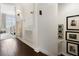 Hallway featuring wood flooring, art and access to the bedroom at 14135 Stowbridge Ave, Tampa, FL 33626