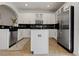 Bright kitchen with stainless steel appliances, white cabinets, and a center island at 14135 Stowbridge Ave, Tampa, FL 33626