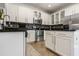 Bright kitchen with stainless steel appliances, white cabinets, and backsplash design at 14135 Stowbridge Ave, Tampa, FL 33626