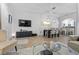 Open-concept living room, seamlessly connecting to the dining area with elegant light fixtures at 14135 Stowbridge Ave, Tampa, FL 33626