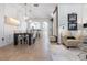 Open living space with dining area, stairs, tile flooring, and neutral color palette at 14135 Stowbridge Ave, Tampa, FL 33626