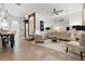 Elegant living room featuring tile floors, a plush sofa, and neutral decor at 14135 Stowbridge Ave, Tampa, FL 33626