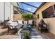 Enclosed patio features a seating area, grill, and a mounted television at 14135 Stowbridge Ave, Tampa, FL 33626