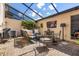 Enclosed patio featuring brick flooring, comfortable seating, and a mounted television at 14135 Stowbridge Ave, Tampa, FL 33626