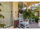 Inviting porch featuring a rocking chair and elegant architectural details near entry door at 14135 Stowbridge Ave, Tampa, FL 33626