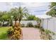 Brick paver walkway with tropical plants and white vinyl fence at 1441 S Hercules Ave, Clearwater, FL 33764
