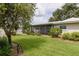 Serene backyard showcasing lush greenery and a screened-in patio, creating a peaceful retreat for relaxation and outdoor enjoyment at 1441 S Hercules Ave, Clearwater, FL 33764