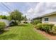 Spacious backyard featuring a lush lawn, mature trees, and a tranquil setting, perfect for outdoor activities and relaxation at 1441 S Hercules Ave, Clearwater, FL 33764