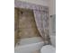 A bathroom with a shower and tub combination and colorful curtains at 1441 S Hercules Ave, Clearwater, FL 33764