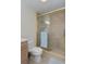 Bathroom featuring a glass shower door, tile surround, toilet, and light wood vanity at 1441 S Hercules Ave, Clearwater, FL 33764