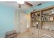 A cozy bedroom features blue walls, ceiling fan, and desk space at 1441 S Hercules Ave, Clearwater, FL 33764