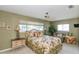 Inviting bedroom with floral bedding, ceiling fan, and a view of the outdoors at 1441 S Hercules Ave, Clearwater, FL 33764