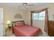 Cozy bedroom features a comfortable bed, a window with natural light, and elegant decor for a relaxing retreat at 1441 S Hercules Ave, Clearwater, FL 33764