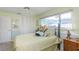 A well-lit bedroom features a large window, an overhead fan and ample closet space at 1441 S Hercules Ave, Clearwater, FL 33764