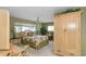 Inviting bedroom with floral bedding, ceiling fan, and a view of the outdoors at 1441 S Hercules Ave, Clearwater, FL 33764