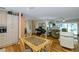 Open-concept dining area flowing into the living room with hardwood floors and lots of natural light at 1441 S Hercules Ave, Clearwater, FL 33764