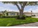 Charming single-story home boasts mature landscaping, a neutral color palette and well manicured lawn at 1441 S Hercules Ave, Clearwater, FL 33764