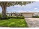 Charming single-story home boasts mature landscaping, a neutral color palette, and a two-car garage at 1441 S Hercules Ave, Clearwater, FL 33764