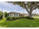 Charming single-story home boasts mature landscaping, a neutral color palette and well manicured lawn at 1441 S Hercules Ave, Clearwater, FL 33764
