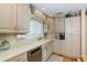Well-lit kitchen features light wood cabinetry, stainless steel dishwasher, and ample counter space at 1441 S Hercules Ave, Clearwater, FL 33764