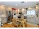 Cozy kitchen with stainless steel appliances, light wood cabinets, and a breakfast table at 1441 S Hercules Ave, Clearwater, FL 33764