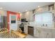 Well-equipped kitchen with stainless steel appliances, wood cabinets, and adjacent dining area at 1441 S Hercules Ave, Clearwater, FL 33764