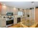 Modern kitchen features stainless steel appliances, light wood cabinets, and a cozy dining nook at 1441 S Hercules Ave, Clearwater, FL 33764