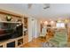 Bright living area opens to the kitchen and features hardwood floors, a recliner, and a large television at 1441 S Hercules Ave, Clearwater, FL 33764