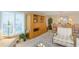 Cozy living room features plush armchairs, soft carpeting, and a built-in wooden shelving unit at 1441 S Hercules Ave, Clearwater, FL 33764