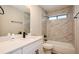 Bright bathroom featuring white cabinets, marble tile surround tub, and modern black fixtures at 14909 Oldgate Pl, Tampa, FL 33624