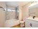 Bathroom with a tub, tiled walls, modern sink, and stylish fixtures at 14909 Oldgate Pl, Tampa, FL 33624