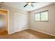 Bedroom with plush carpeting, ceiling fan, a double door closet, and natural light from a window at 14909 Oldgate Pl, Tampa, FL 33624