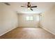 Bedroom featuring neutral walls, carpeted flooring, a ceiling fan, and natural lighting at 14909 Oldgate Pl, Tampa, FL 33624