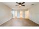Spacious carpeted bedroom with ceiling fan, walk-in closet, and an ensuite bathroom at 14909 Oldgate Pl, Tampa, FL 33624