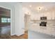 Open kitchen with island, granite countertops, modern lighting, and stainless steel appliances at 14909 Oldgate Pl, Tampa, FL 33624
