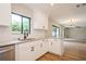 Modern kitchen featuring white cabinets, granite countertops, and a stylish faucet with natural light at 14909 Oldgate Pl, Tampa, FL 33624