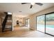 Spacious open floor plan showing new floors, leading to a modern kitchen and sliding glass doors to the pool at 14909 Oldgate Pl, Tampa, FL 33624
